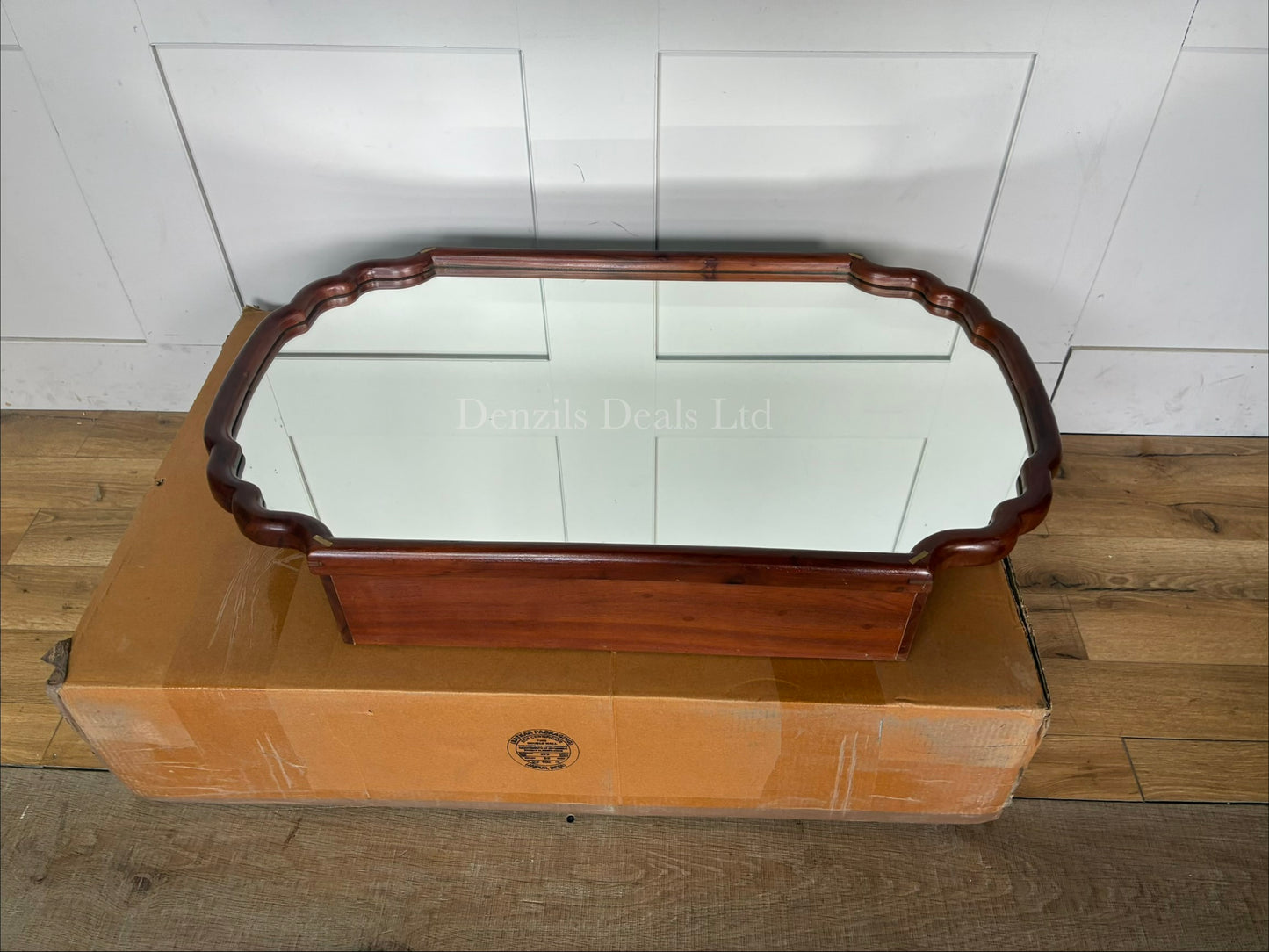 Anthropologie Wall-mounted wooden medicine cabinet with a mirrored door, scalloped edge silhouette, and brass accents
