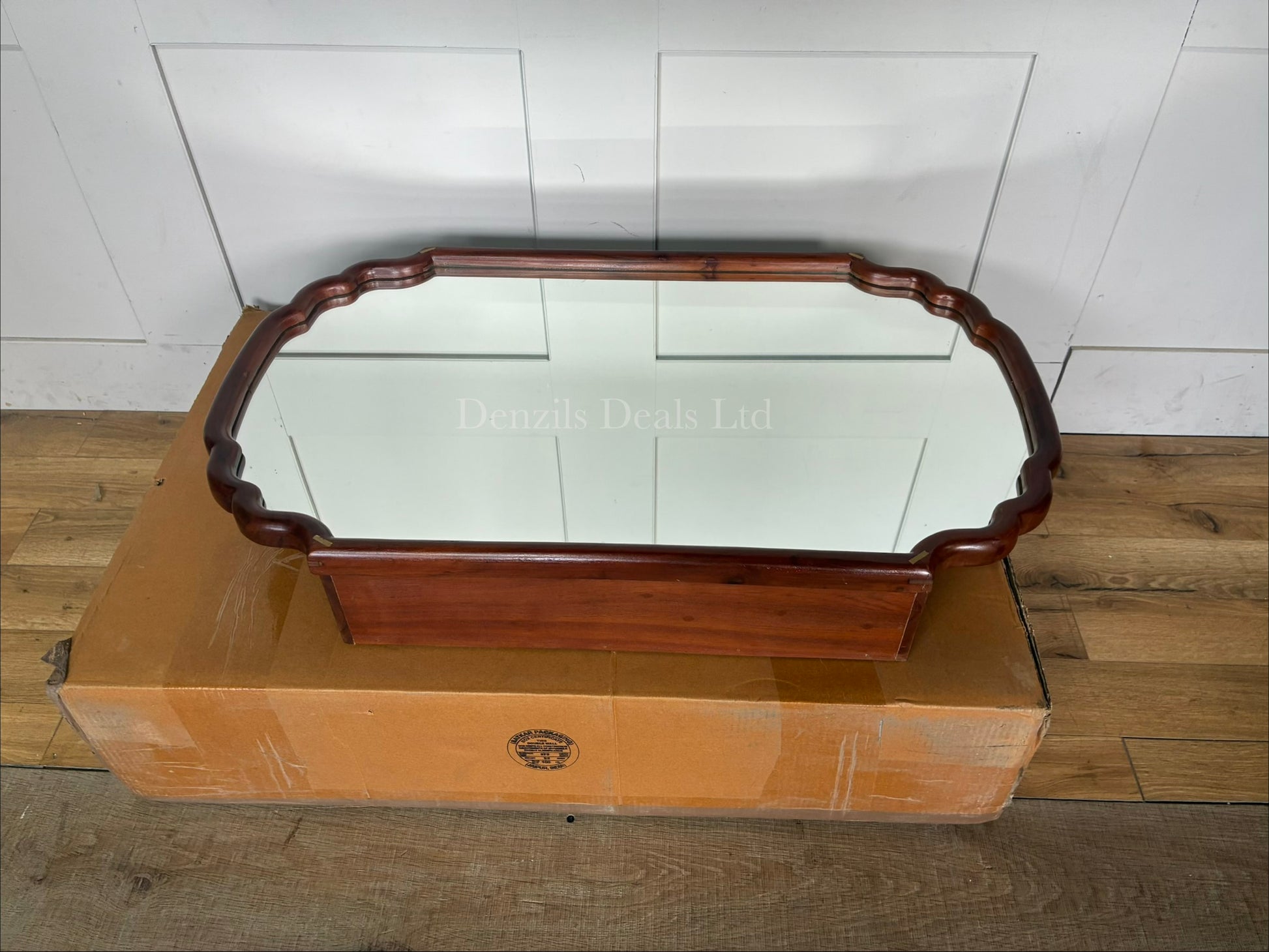 Anthropologie Wall-mounted wooden medicine cabinet with a mirrored door, scalloped edge silhouette, and brass accents