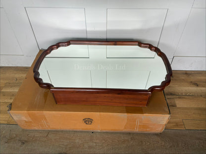 Anthropologie Wall-mounted wooden medicine cabinet with a mirrored door, scalloped edge silhouette, and brass accents