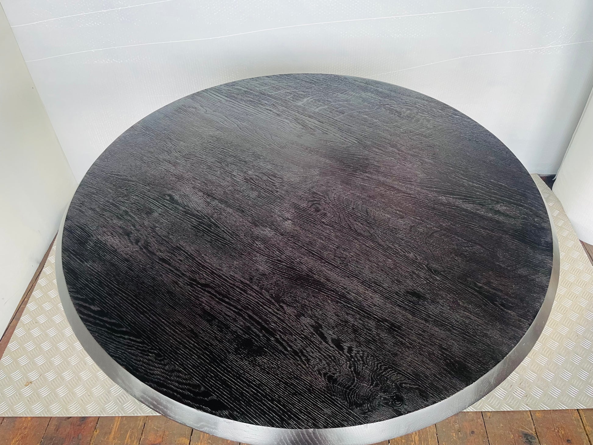 Anthropologie's black oak Iris dining table styled in a modern dining room,