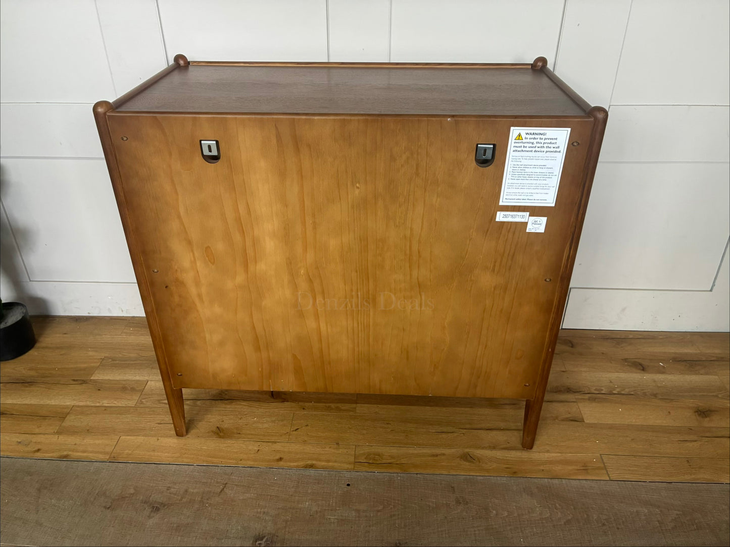 Back view Minimalist mid-century modern 3-drawer dresser by John Lewis, crafted from wood with a warm walnut stain, tray-edge top, and sleek handle-less design."