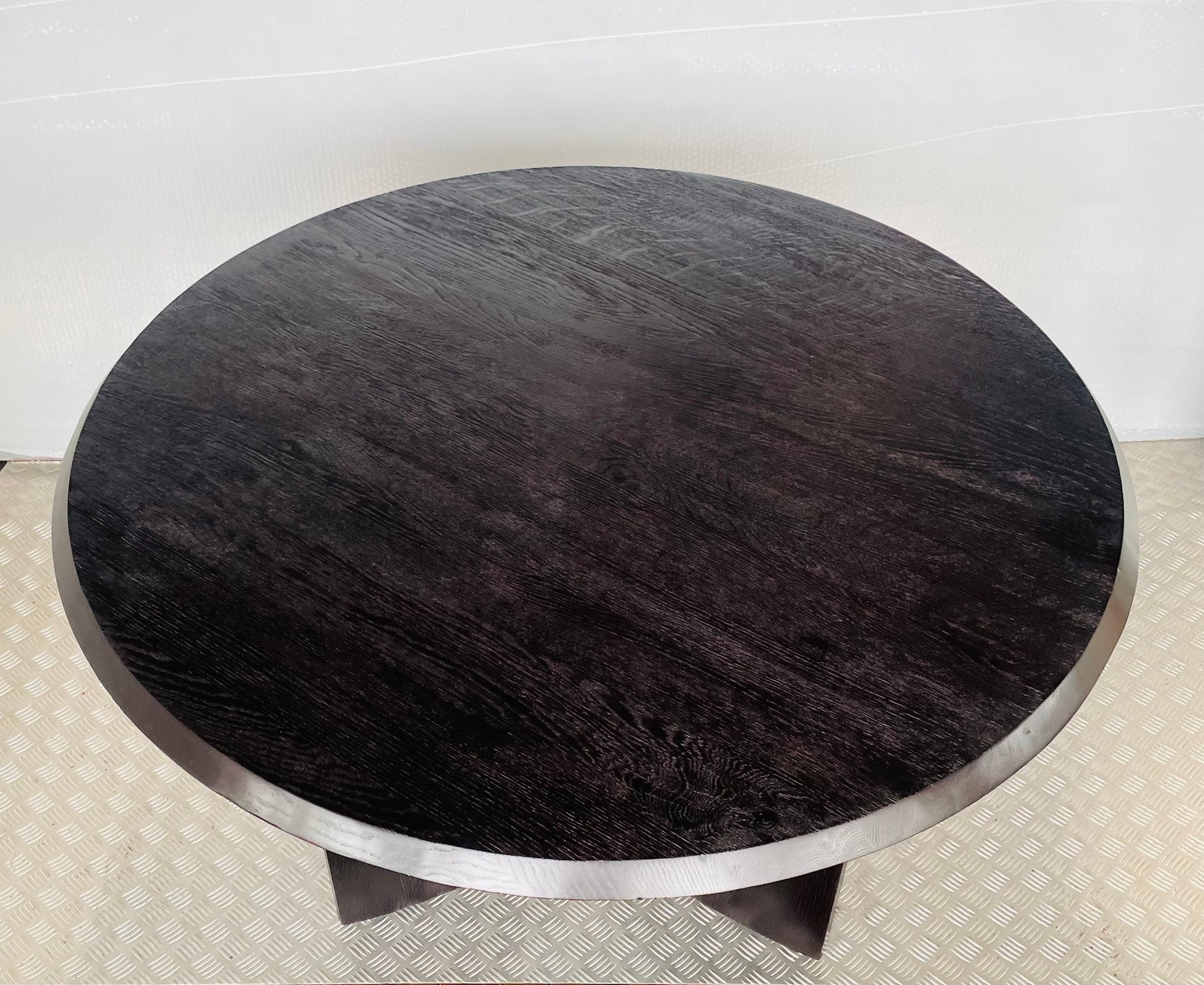 Black Anthropologie Iris Dining Table featuring vertical fluted detailing along the cylindrical base. Close up top view 