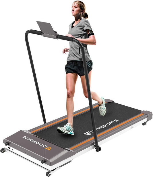 Black Citysports folding walking pad treadmill set up under a standing desk in a home office, showing its slim profile and digital LED display.