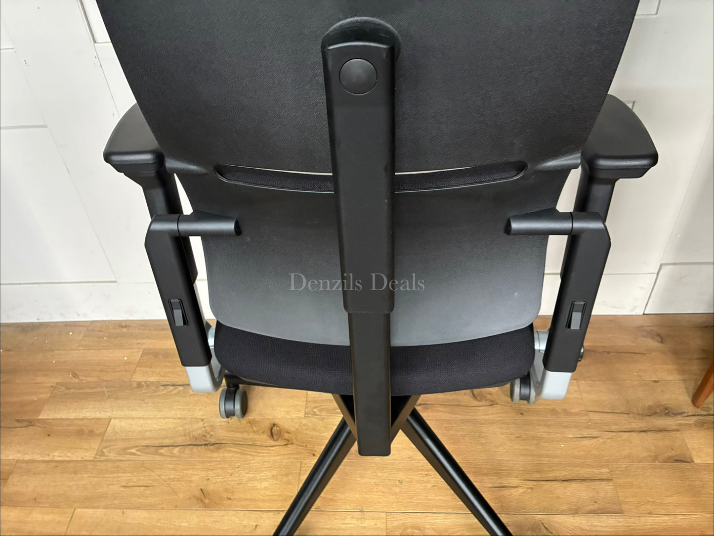 Black Steelcase Please ergonomic desk chair with a headrest.