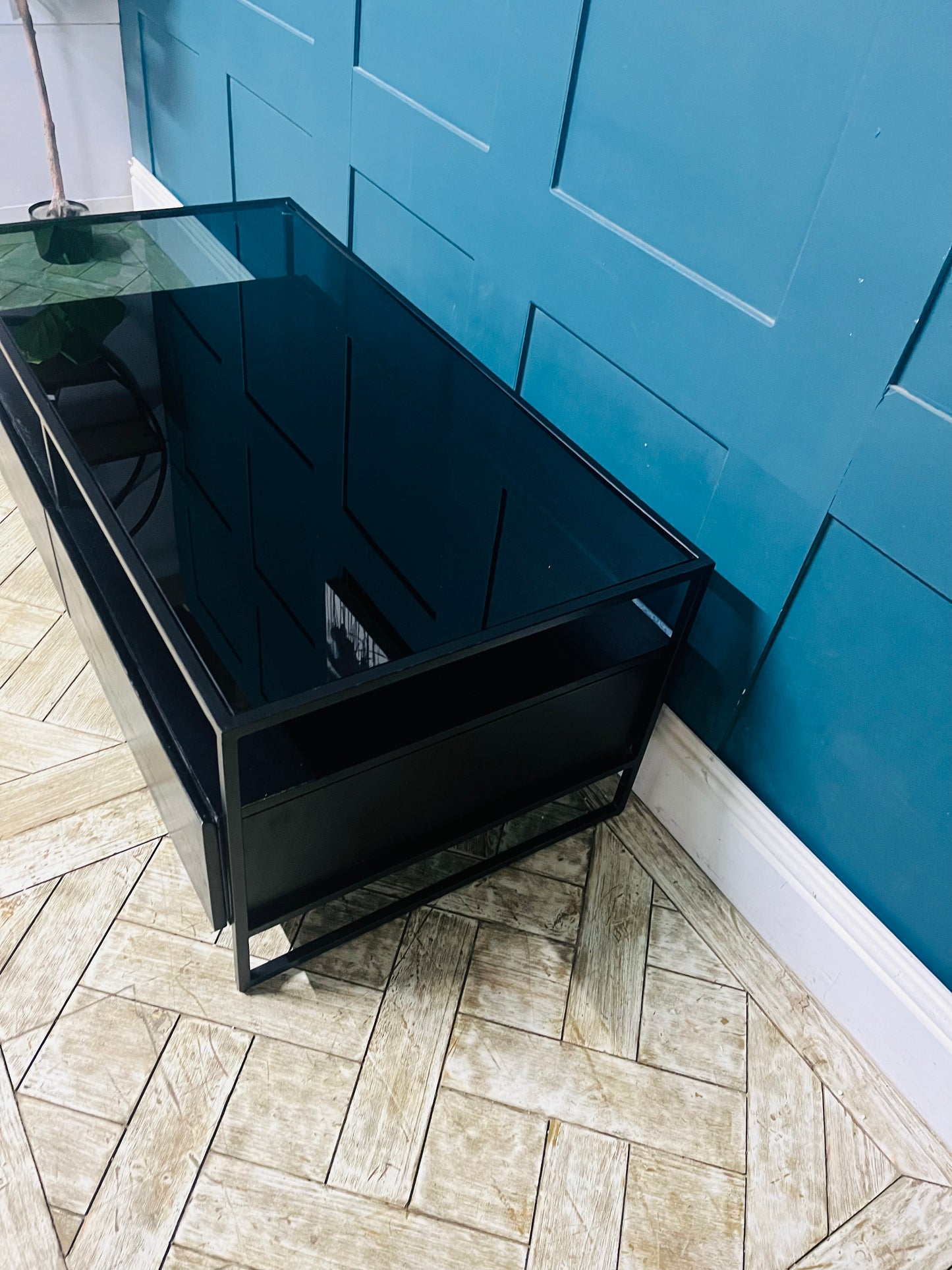 Modern Kilby coffee table by Made.com featuring black metal lines and a sleek smoked glass top