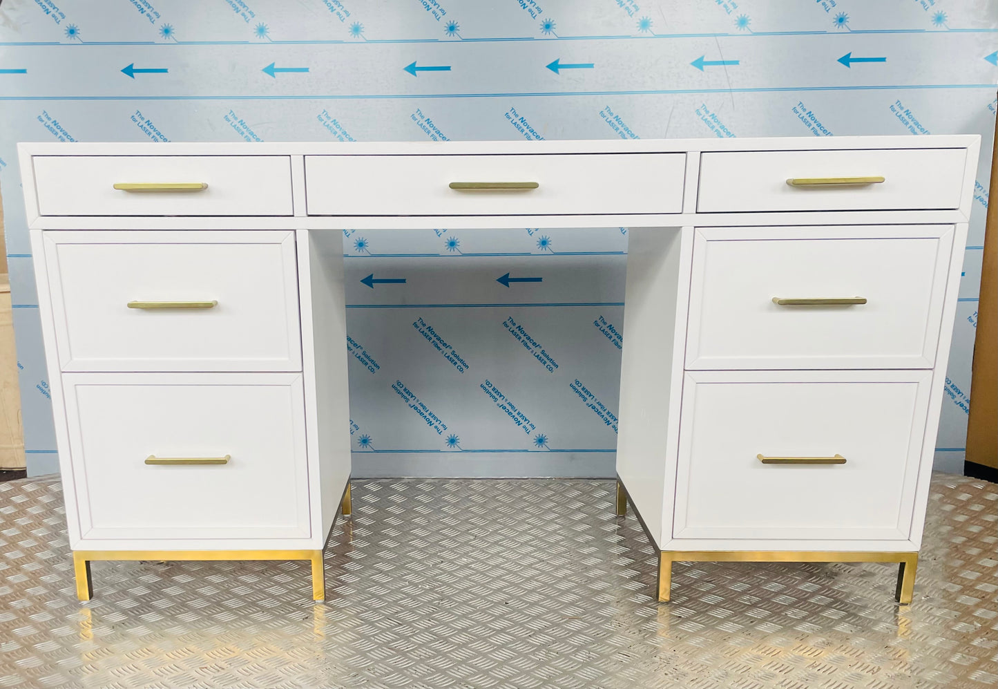 Close-up of the Blaire smart storage desk, highlighting smooth white wood finish and metallic gold hardware."
