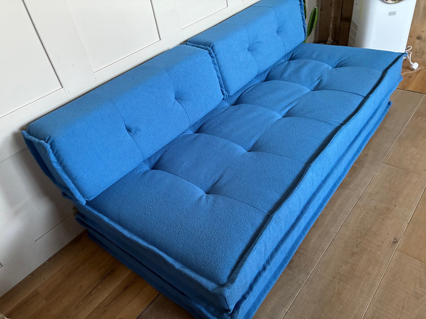 Blue contemporary Macy double sofa bed converted into a spacious floor-level sleeper."