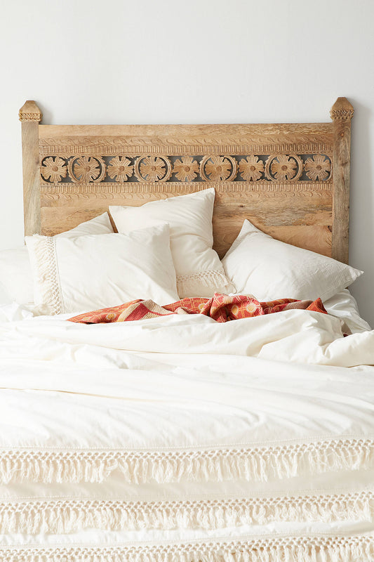 Bohemian style Super Kingsize headboard made of natural mango wood with intricate carved floral motifs, featuring a rectangular design and two legs for bed attachment.