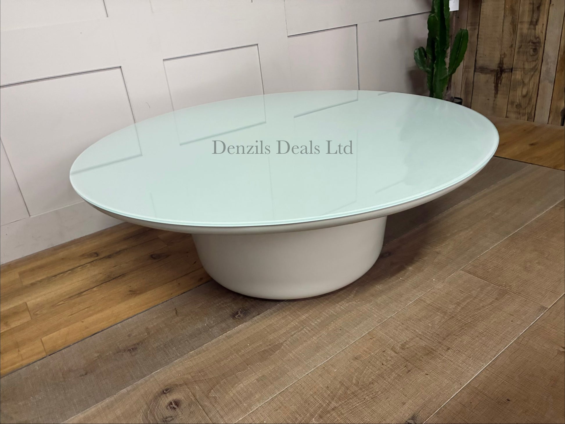Chic, modern 42-inch round concrete coffee table with a sleek glass top, perfect for patio drinks or a modern living room.