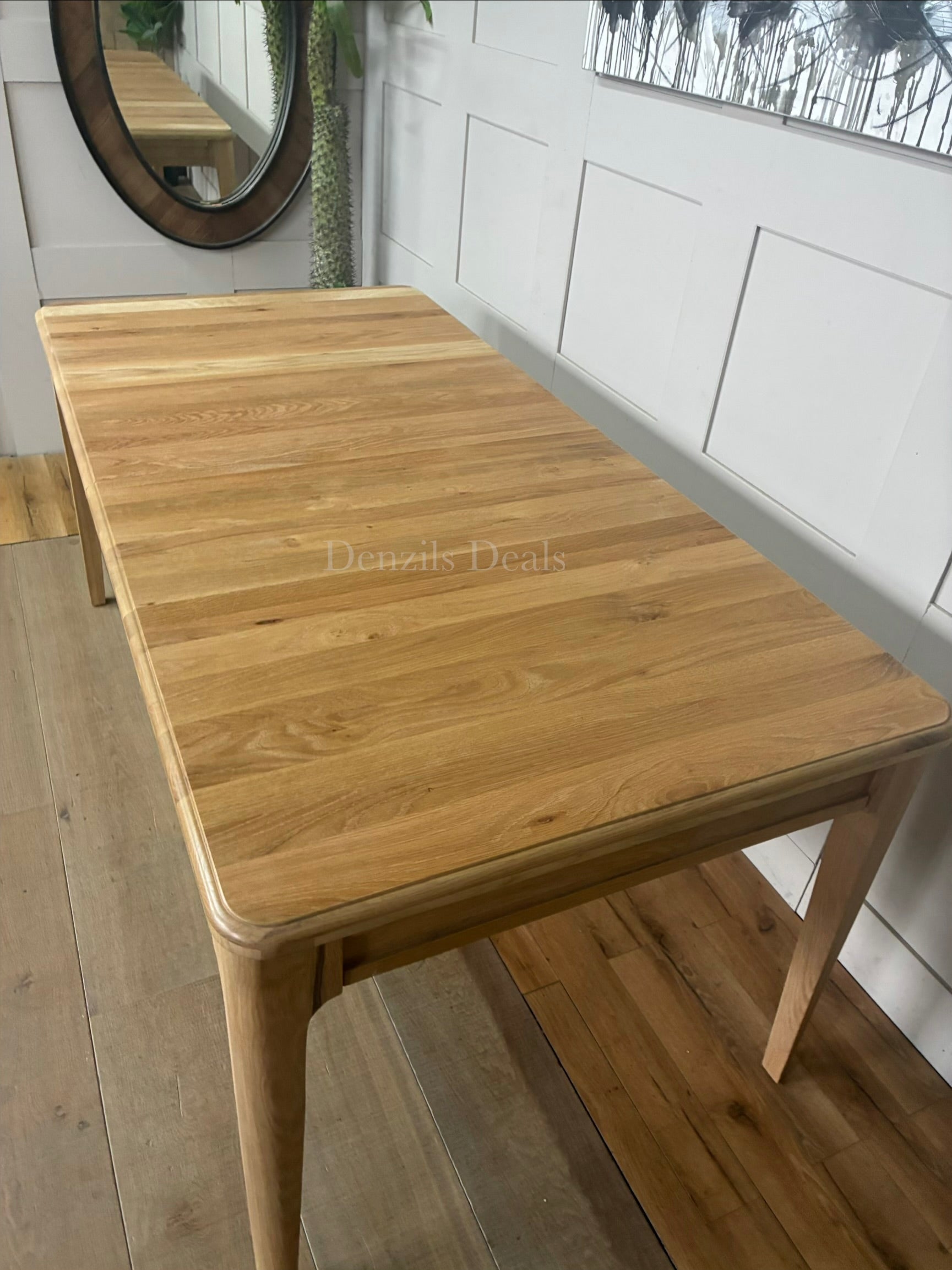 Close-up of the pale matt finish and smooth solid oak grain on the NEWTON extendable dining table."