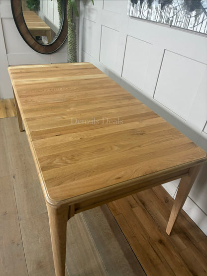 Close-up of the pale matt finish and smooth solid oak grain on the NEWTON extendable dining table."