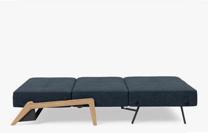 Close-up detail of the durable, woven Nist Blue 515 fabric upholstery on an Innovation Living Cubed Sofa showing the rich, textured blue color and modern stitching."