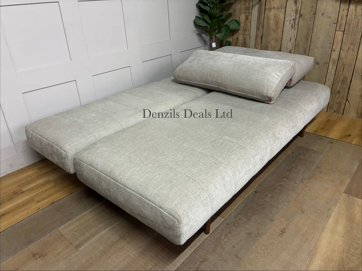 Close-up of the Innovation Living Avella Sand 280 upholstery fabric, showing a smooth, even, tightly woven polyester texture in a light sandy-beige tone.