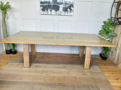 Close-up of the light timber grain and angular legs on the Nick Scali Natami dining table.