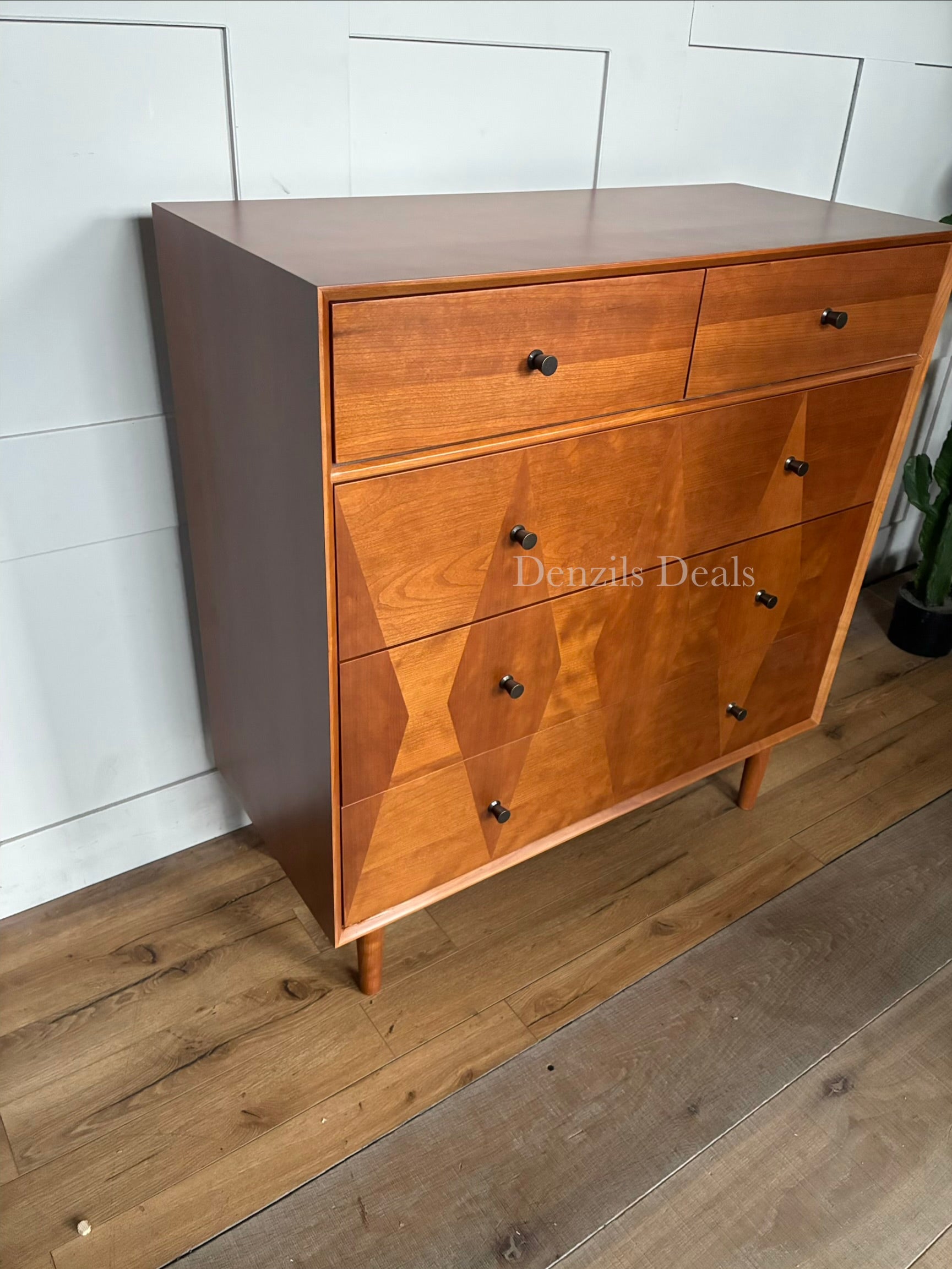 Close-up of the marquetry technique on the drawer fronts, highlighting contrasting light and dark natural wood panels."
