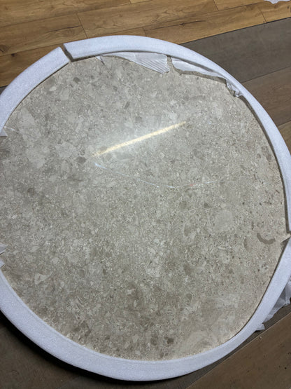 Close-up shot of the cream and beige veined marble surface and dark brown wooden base of the John Lewis Ritz dining table