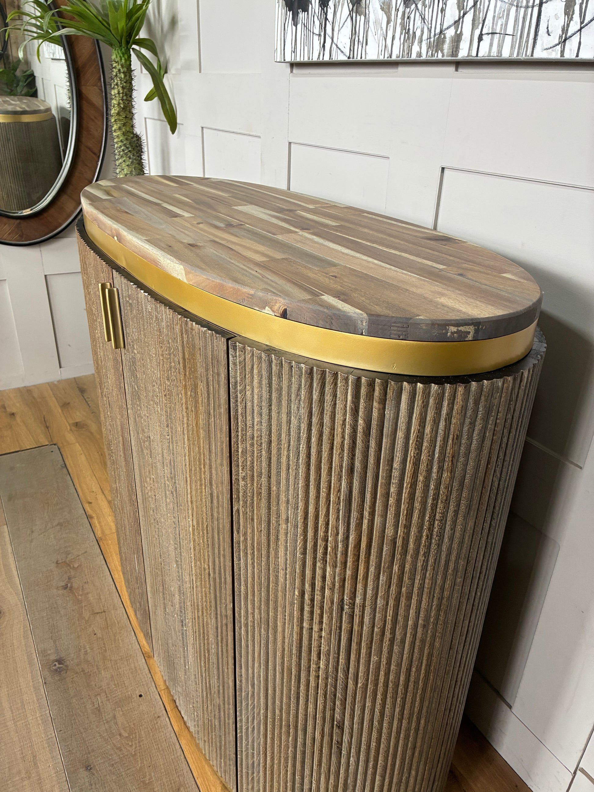 Close-up shot of the RV Astley Maigue bar cabinet showcasing the seamless transition between the vertically ribbed brown wood exterior and the smooth wooden top.