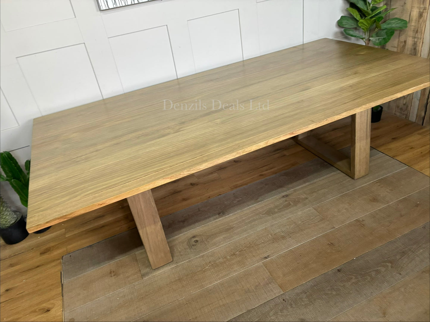 Close-up of the light timber grain and angular legs on the Nick Scali Natami dining table.