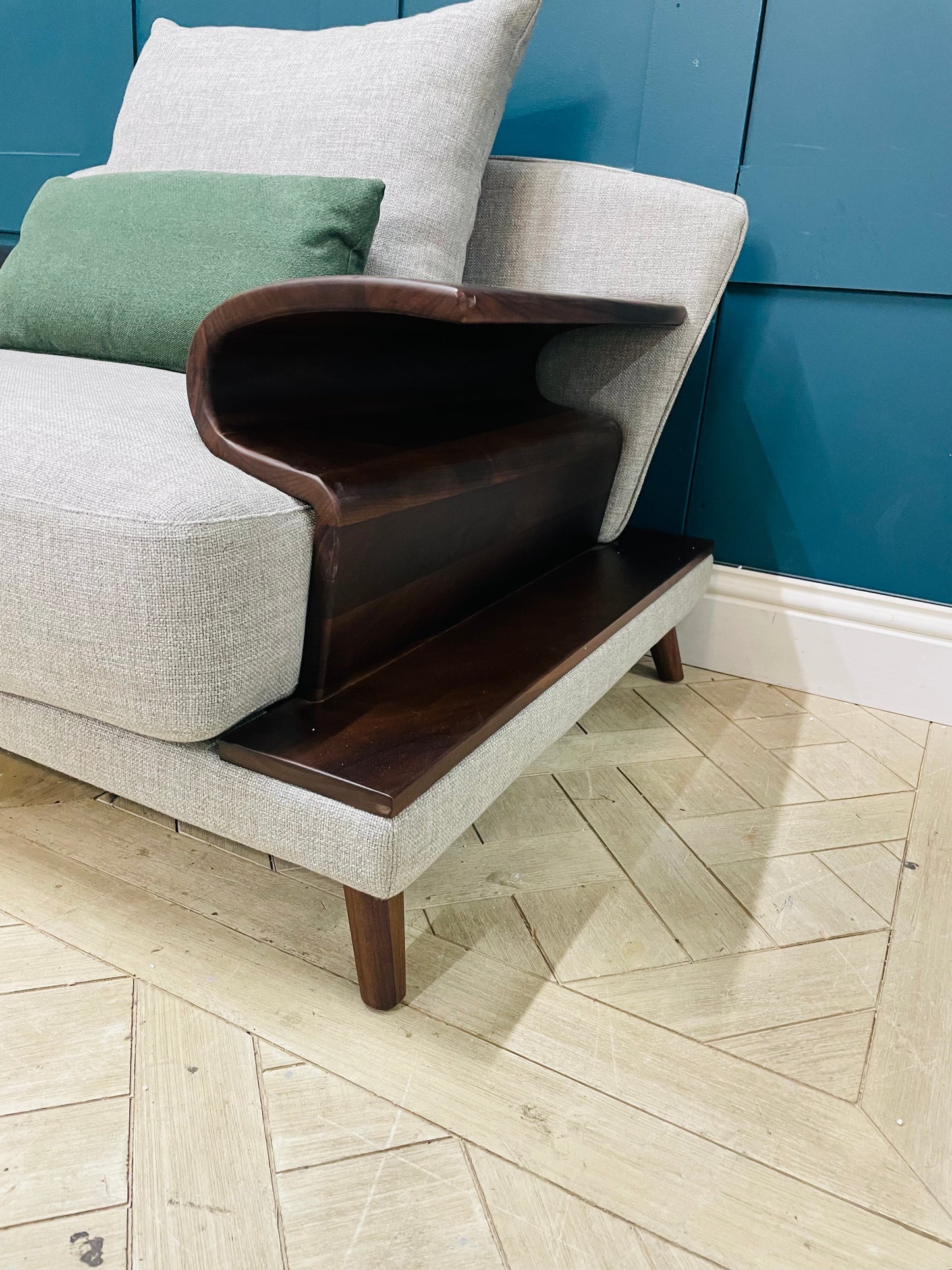 Comfortable grey upholstered armchair with plush seating and contemporary statement design