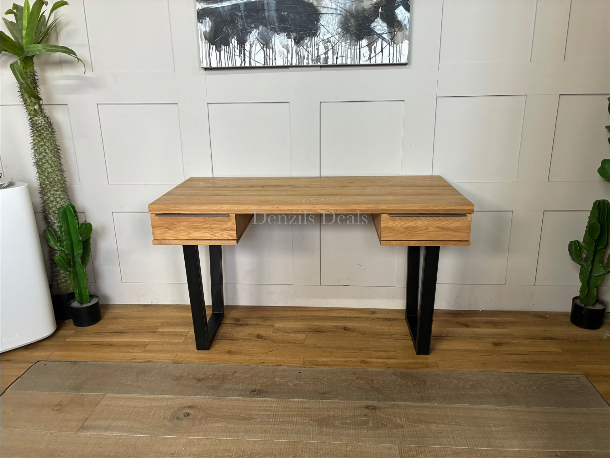 Compact home office desk made from solid oak with a wire-brushed, distressed finish. It features two sliding drawers with slim iron handles and sits on a minimalist, square-shaped black iron frame