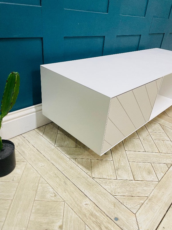 Media console by Content by Terence Conran in white with a geometric diagonal pattern on the doors and exposed wooden legs
