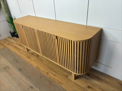Curved oak sideboard and media unit by John Lewis featuring a vertical slatted wood front, closed storage cabinets, and natural light oak finish."