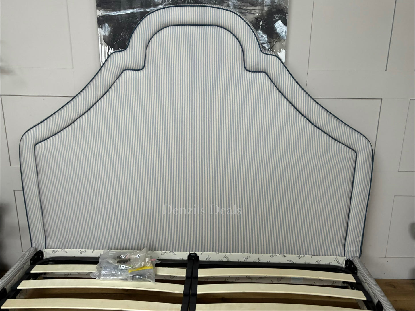 DFS Upholstered super king bed frame in a vibrant Joules hand-drawn blue ticking stripe  fabric with a dramatic tall headboard and sleek dark wood carved feet