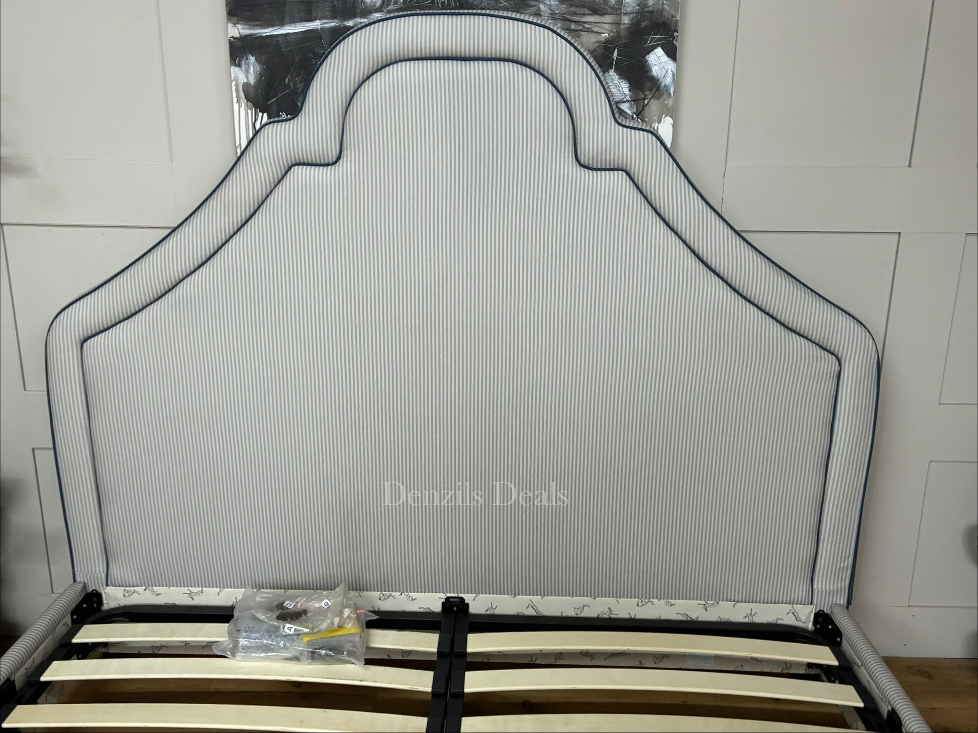DFS Upholstered super king bed frame in a vibrant Joules hand-drawn blue ticking stripe  fabric with a dramatic tall headboard and sleek dark wood carved feet