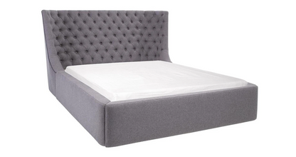 Dfs Elegant king size ottoman bed upholstered in grey fabric with a traditional buttoned headboard. Close up view on headboard 
