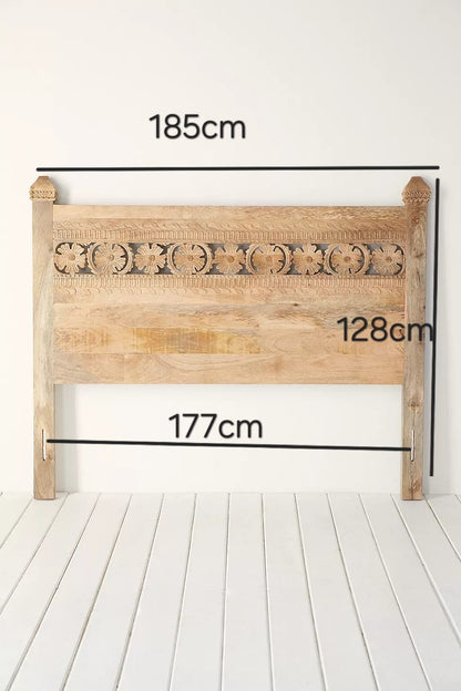 Bohemian style Super Kingsize headboard made of natural mango wood with intricate carved floral motifs, featuring a rectangular design and two legs for bed attachment. Showing dimensions 