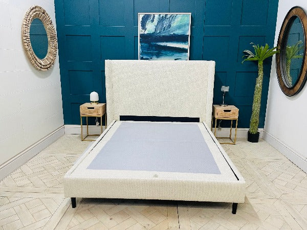 Doddington King Size Bed in Corto Ivory Bouclé fabric with a chic winged headboard and modern black feet.