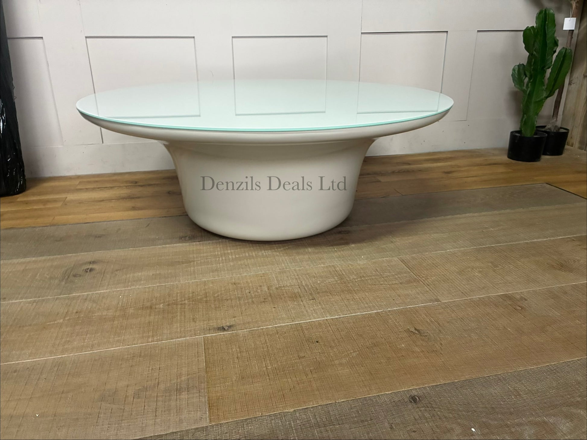 Close-up of the Dulce 42” modern round coffee table highlighting its chunky, cylindrical pedestal base made from textured, light-grey concrete