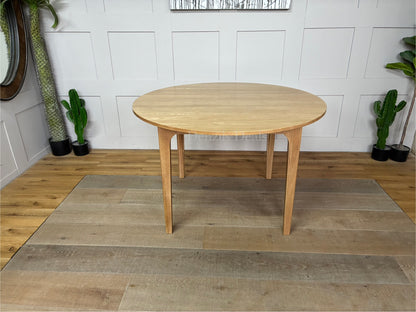 OAK ROUND DINING TABLE 120CM DURHAM NATURAL By OAK FURNITURELAND Constructed entirely from solid oak with a light, grain-enhancing natural finish.