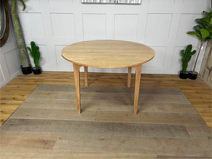 OAK ROUND DINING TABLE 120CM DURHAM NATURAL By OAK FURNITURELAND Constructed entirely from solid oak with a light, grain-enhancing natural finish.