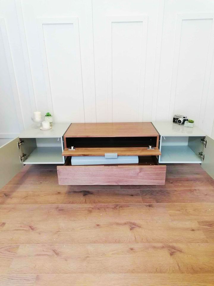 Dwell Sturado TV unit featuring a grey and wood-effect body with clear glass supports.