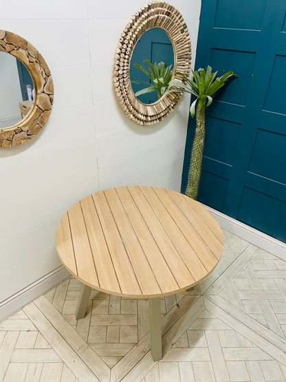 Eton round dining table in Prairie finish, featuring a light oak wood top and grey pedestal base by Gallery Direct.