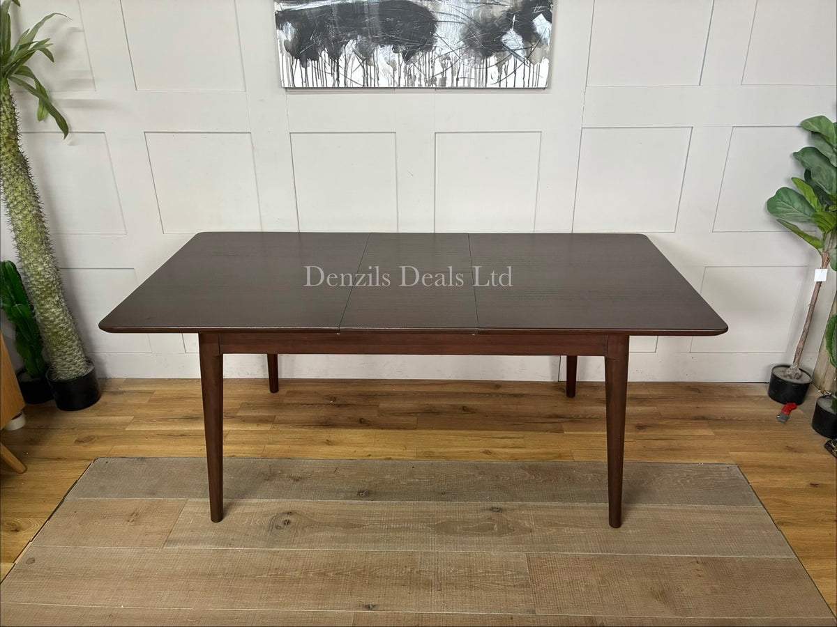 Mid-century modern dark walnut wooden dining table with a smooth rectangular top and tapered legs, designed to seat four to six people by Fishe and Lilly 