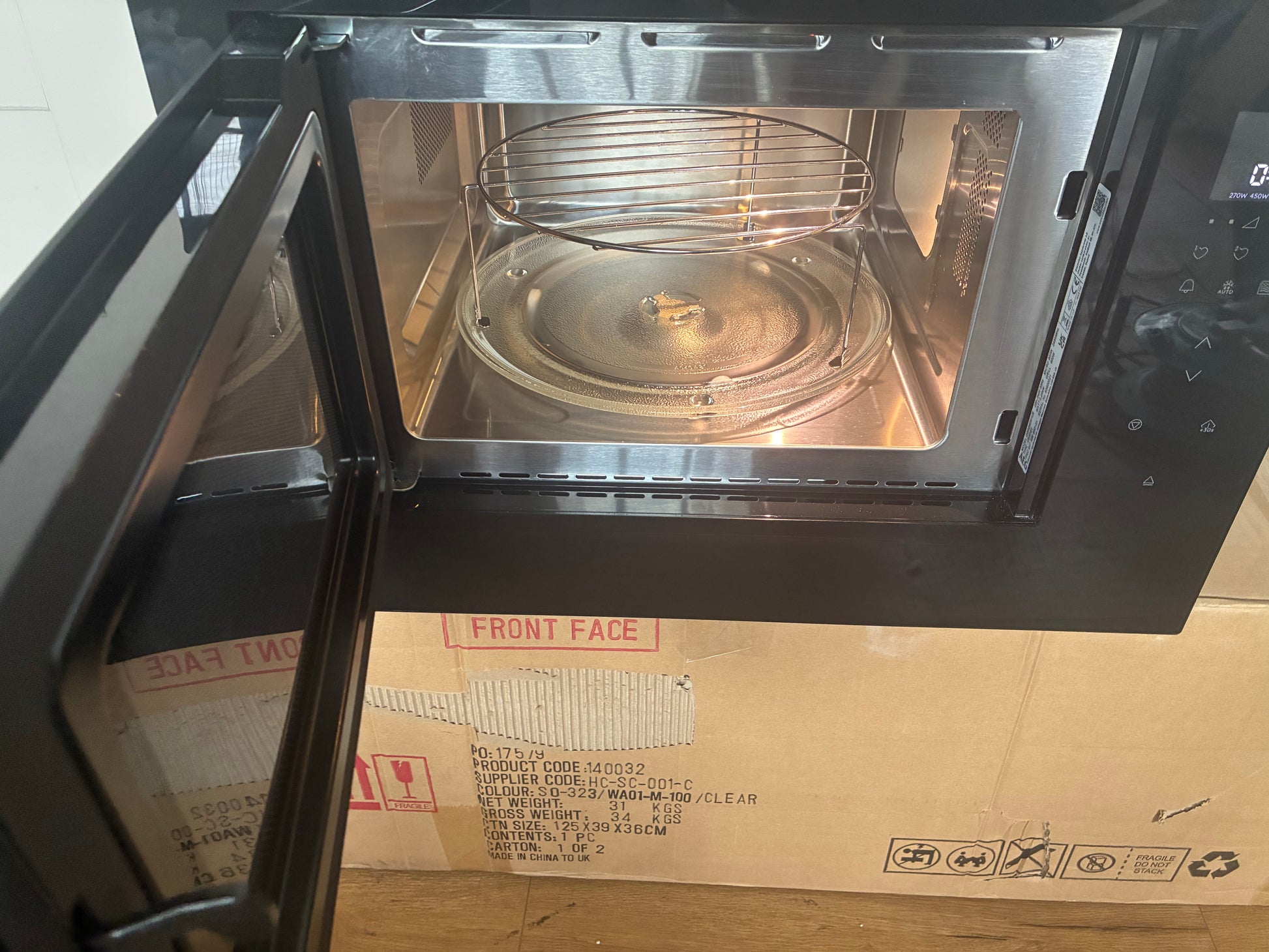 Flush-fit AEG 26L built-in microwave (model OB6SM261UB) finished in black glass. Shows the 900W electronic solo microwave with an effortless push-button door, designed to seamlessly integrate into tall kitchen housing