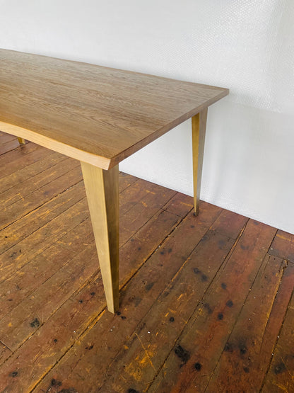 Industrial style Frank Hudson Foundry 180cm dining table with solid oak grain and bronze-finished metal base. Close up view of leg