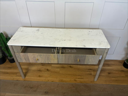 Marmo Marble Top 2 Drawer Console Table with a polished white Indian Carrera marble surface with unique grey and blue veining, Crafted from solid mango wood with a grey-wash finish, two drawers feature striking vertical ribbed textures that provide architectural depth. Finished with elegant round button knobs, typically in brass or gold-toned metal