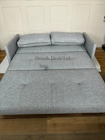 Front view of the Innovation Living Cubed 160 Sofa Bed in Twist Granite. The compact, armless three-seater sofa features a dark grey, textured weave fabric with two large matching back cushions and stands on low, slim black matte metal legs.