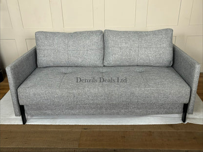 Front view of the Innovation Living Cubed 160 Sofa Bed in Twist Granite. The compact, armless three-seater sofa features a dark grey, textured weave fabric with two large matching back cushions and stands on low, slim black matte metal legs.