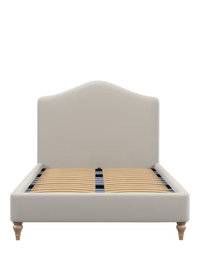 Front view of the king-size John Lewis Alice Bed Frame, showcasing a beige fabric headboard with a gentle curve, vertical seaming, and light-colored wooden legs