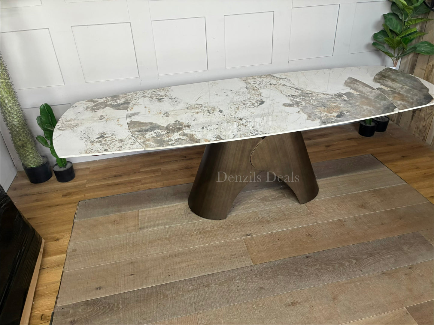 Gallery Direct Bresso Bronze Extending Dining Table with a marble-effect ceramic top and a matte bronze metal base, shown in its closed position to accommodate 6 seats.