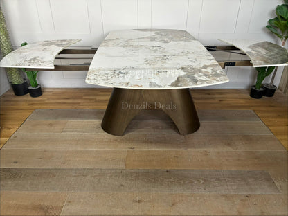 Gallery Direct Bresso Bronze Extending Dining Table with a marble-effect ceramic top and a matte bronze metal base, shown in its closed position to accommodate 6 seats.
