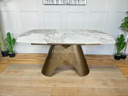 Gallery Direct Bresso extending dining table featuring a white Carrara marble-style ceramic top and a modern matt bronze metal base."