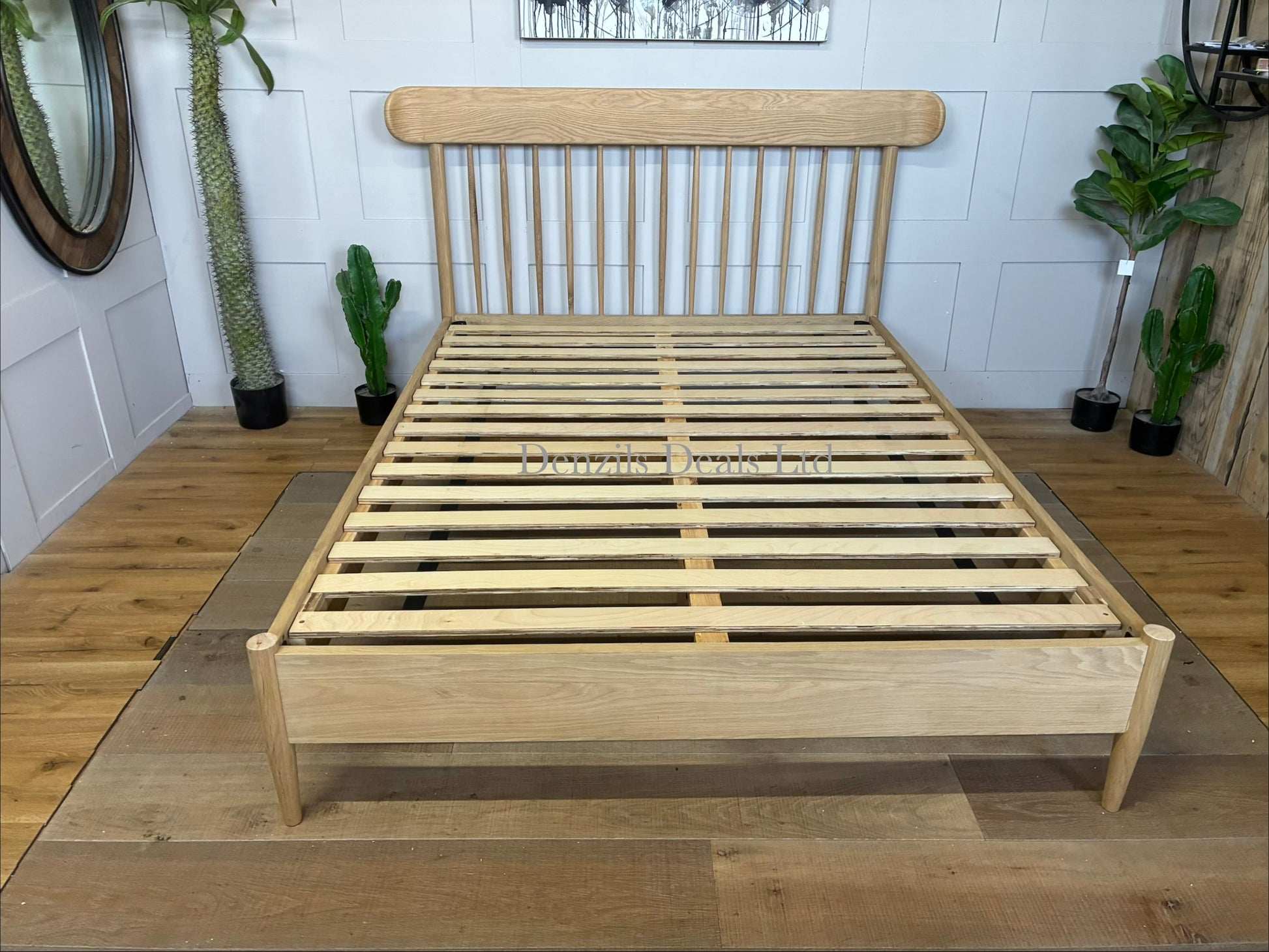 Gallery Direct Hatfield king size bed frame made from natural oak, featuring a spindle headboard and a minimalist wooden design