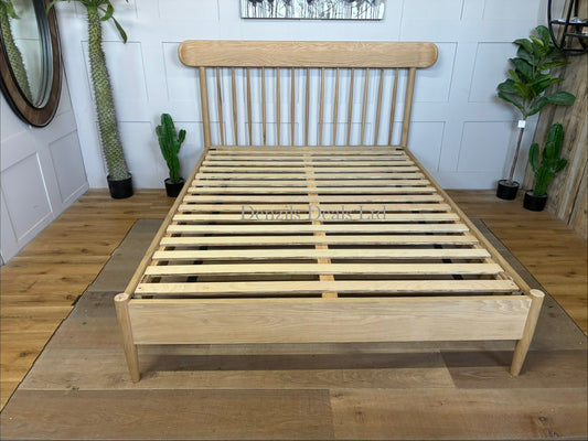 Gallery Direct Hatfield king size bed frame made from natural oak, featuring a spindle headboard and a minimalist wooden design