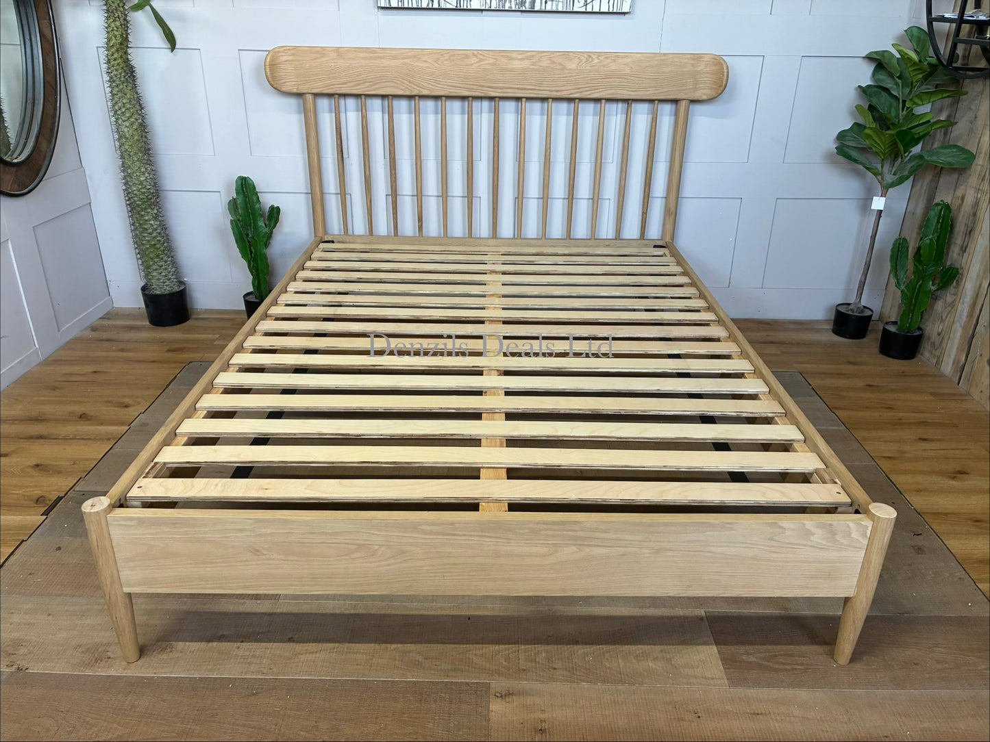 Gallery Direct Hatfield king size bed frame made from natural oak, featuring a spindle headboard and a minimalist wooden design