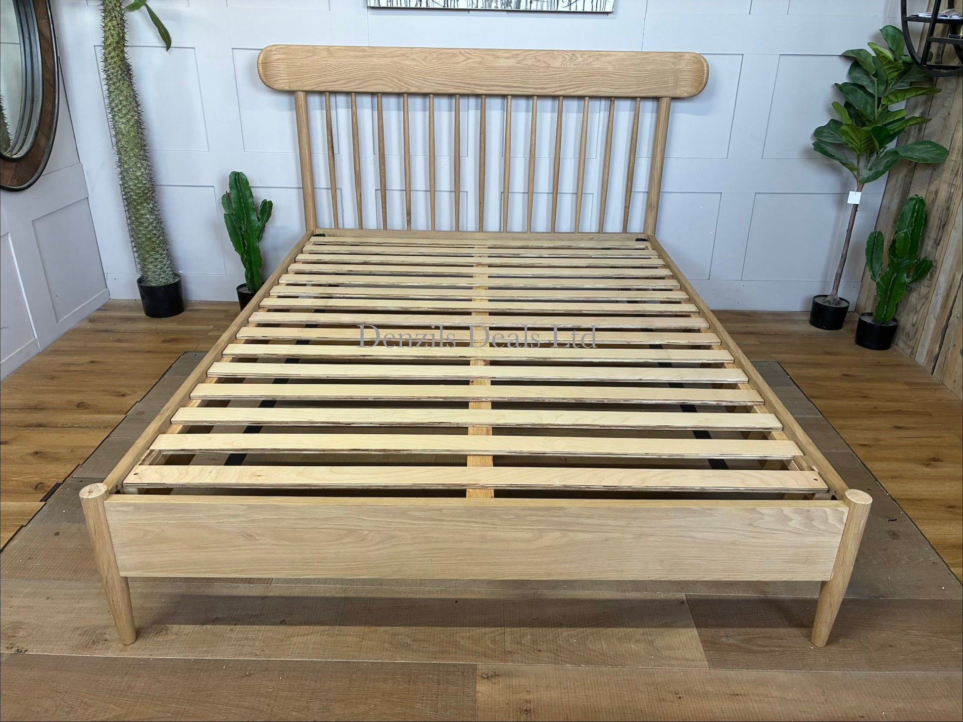 Gallery Direct Hatfield king size bed frame made from natural oak, featuring a spindle headboard and a minimalist wooden design
